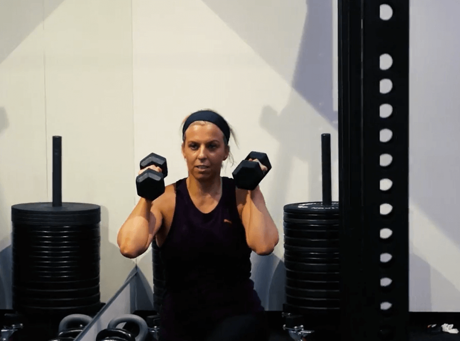 Woman training with dumbbells at MFW Fitness Studio